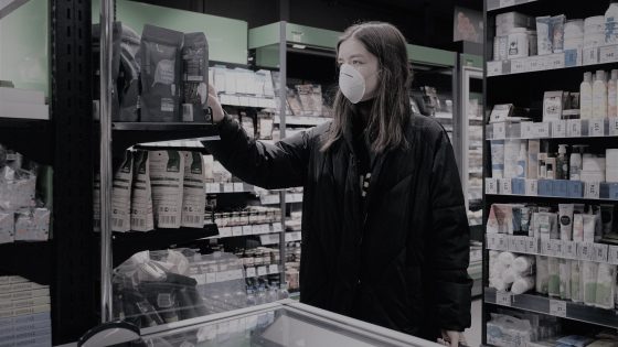 woman in face mask shopping in supermarket 3987216